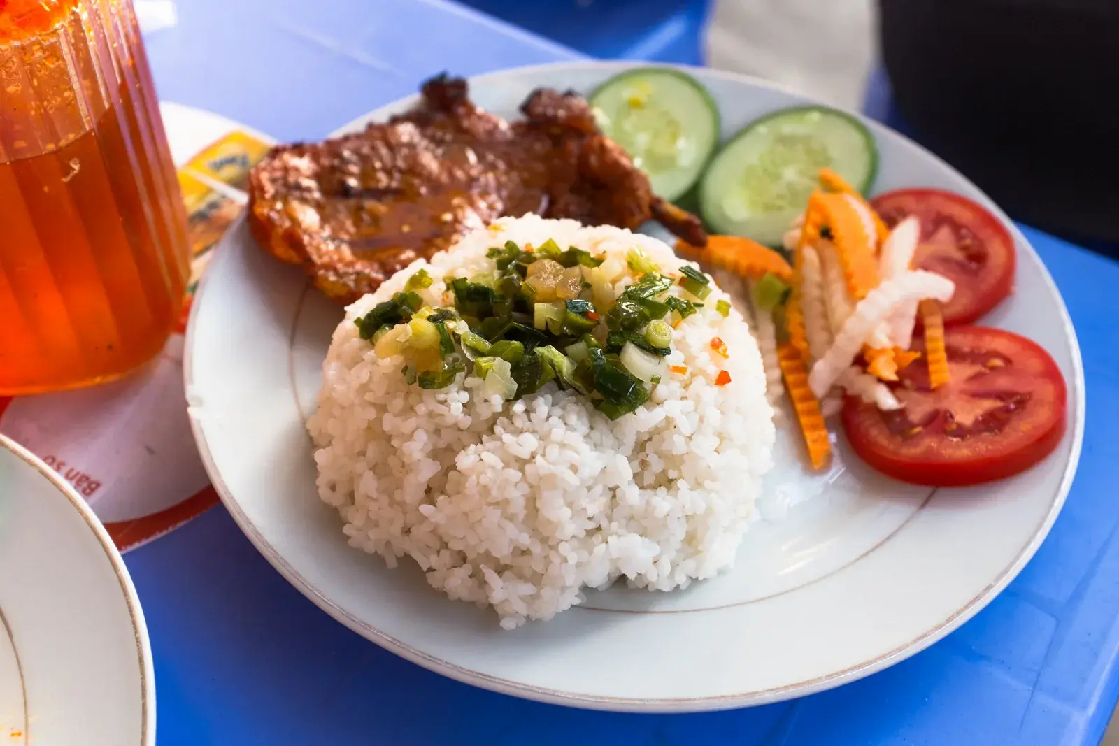 Plate of Com Tam broken rice with grilled pork in Vietnam