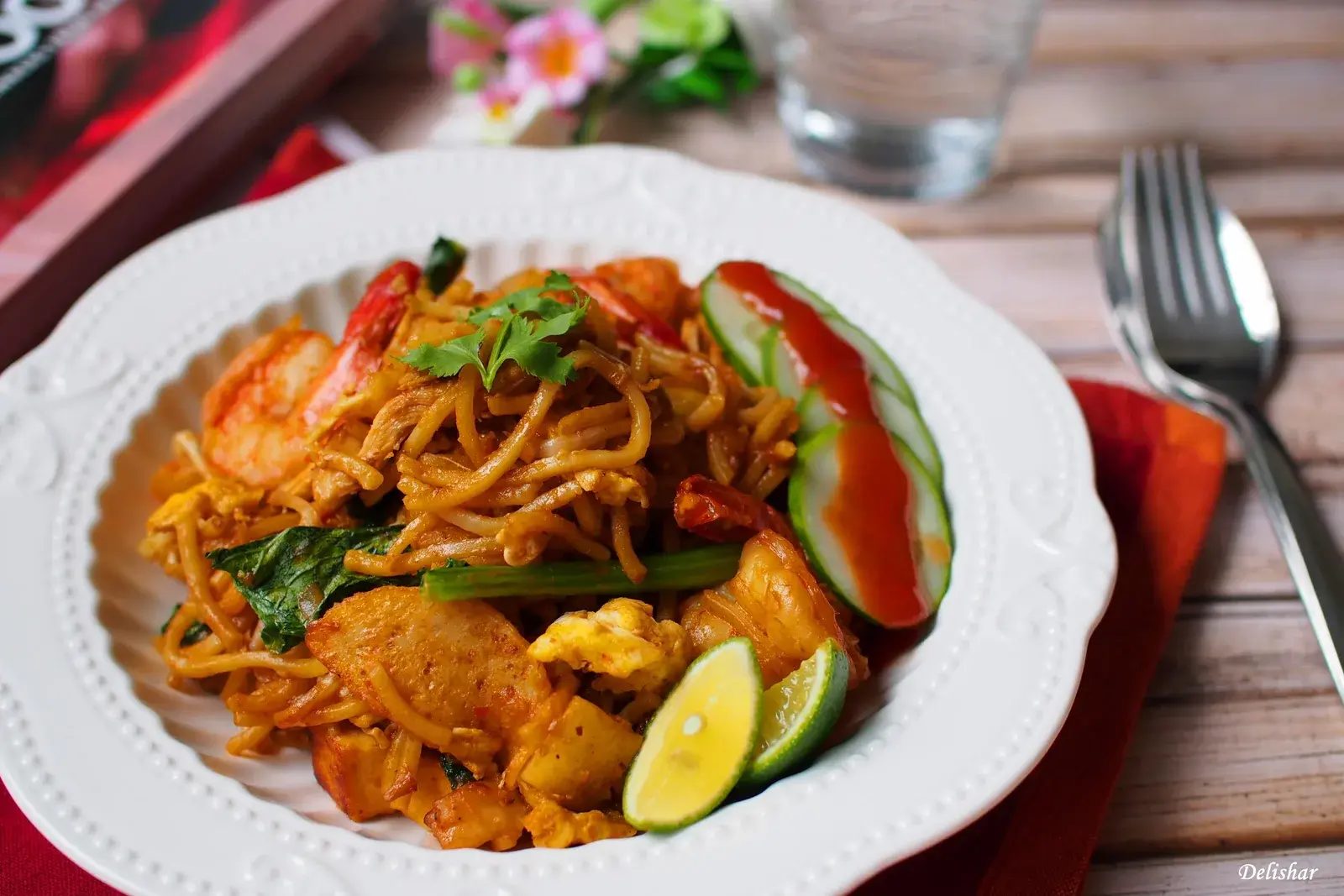 Plate of spicy Mee Goreng Mamak fried noodles with egg and vegetables