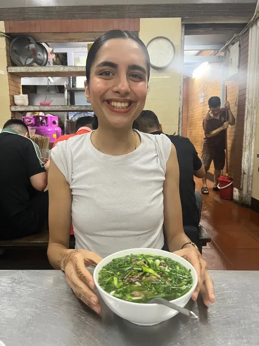 Bowl of traditional Pho noodle soup with herbs in Vietnam