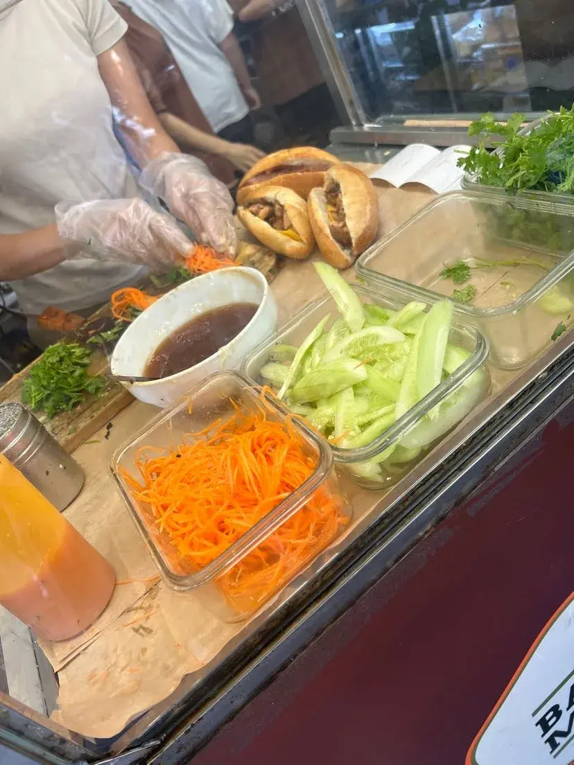 Street vendor preparing Banh Mi sandwiches in Hanoi, Vietnam
