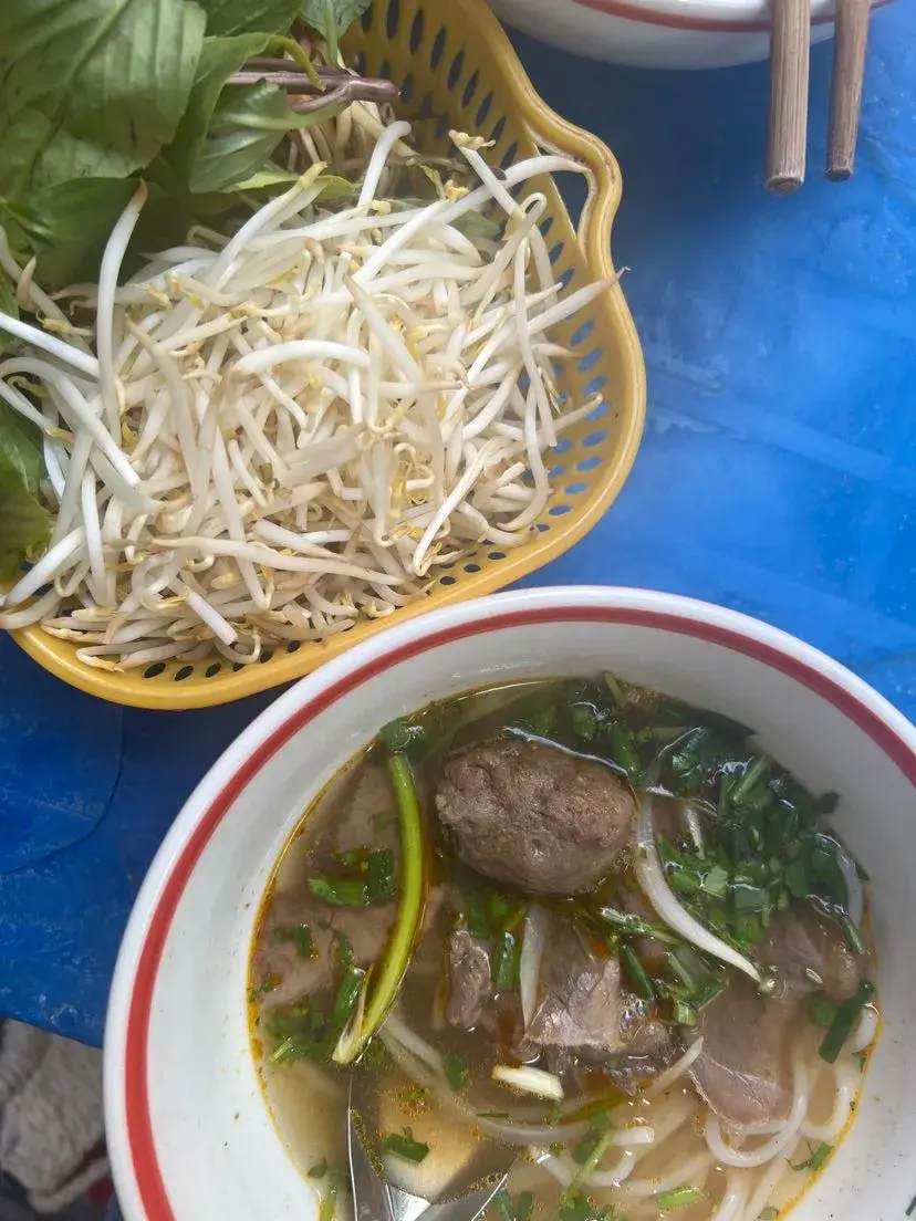 Bowl of spicy Bun Bo Hue lemongrass noodle soup in Hanoi