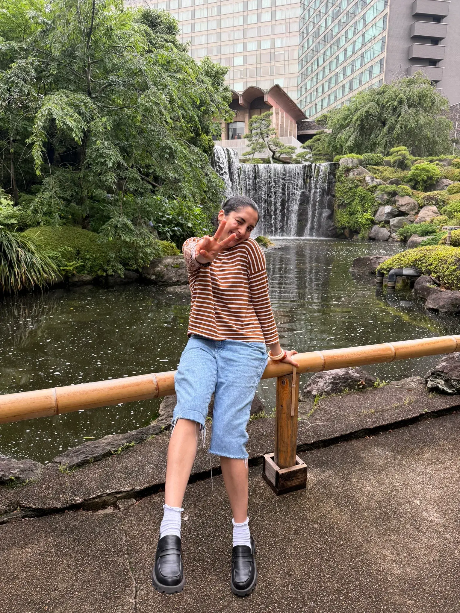 Beautiful Japanese garden with a pond and waterfall at Hotel New Ohtani Japanese Garden in Tokyo