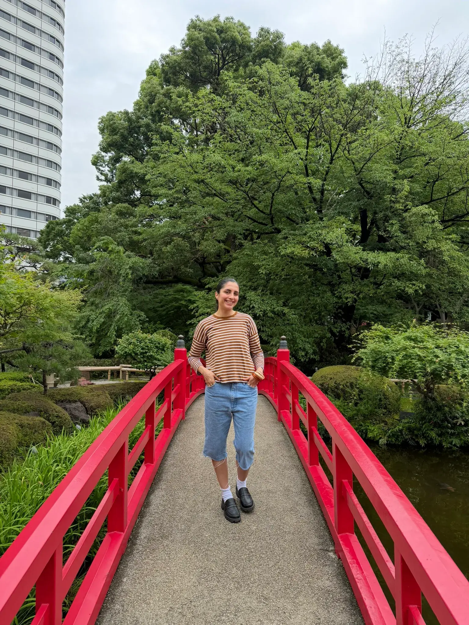 Beautiful Japanese garden with a pond and waterfall at Hotel New Ohtani Japanese Garden in Tokyo
