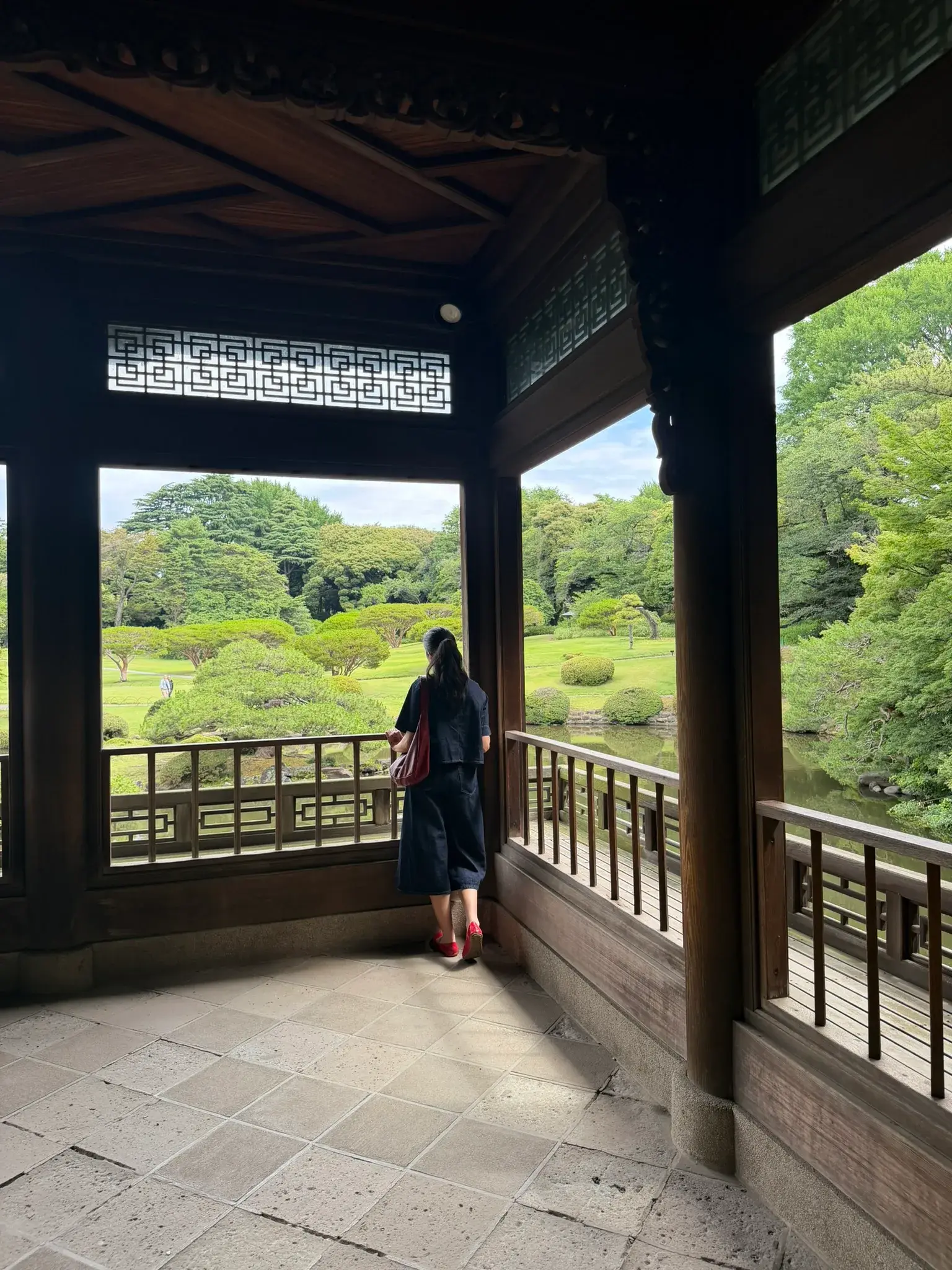Traditional garden with a pond and greenery at Shinjuku Gyoen National Garden in Tokyo