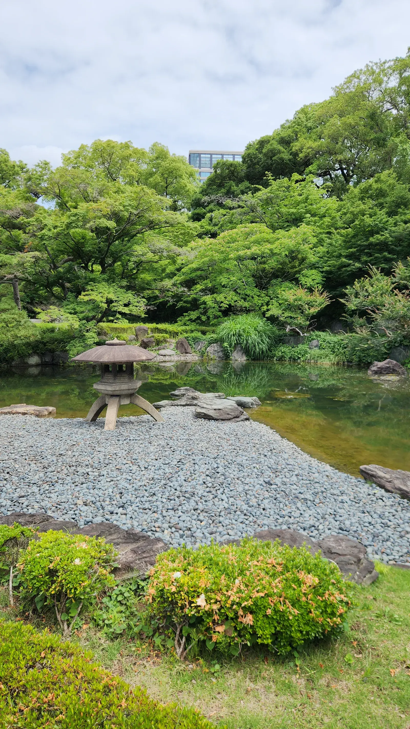 Beautiful garden with a pond and greenery at the Imperial Palace Gardens in Tokyo